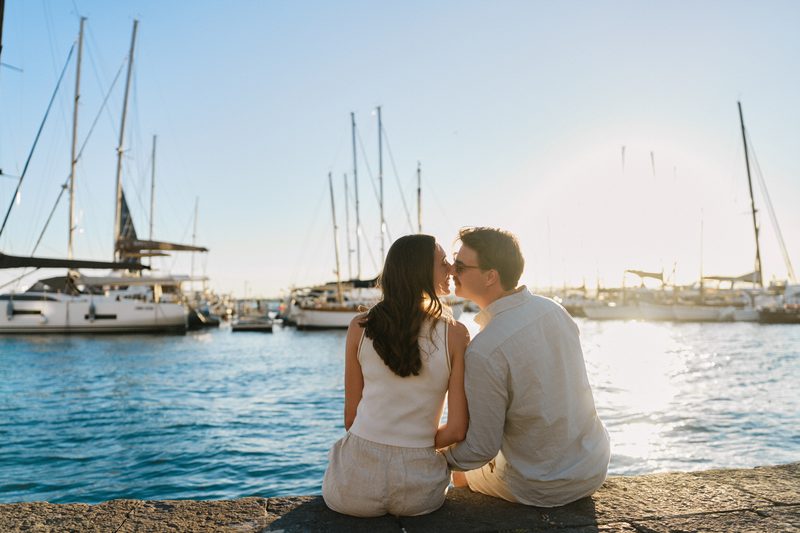 A couple sitting by the water at the Marina of Ortigia
